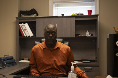 A man sits at a desk in an office