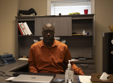 A man sits at a desk in an office