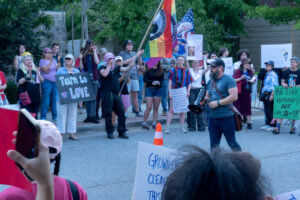 Tim Denson speaks to a crowd of protesters