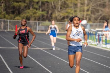 An Apalachee track runner competes against a rival from Winder-Barrow.