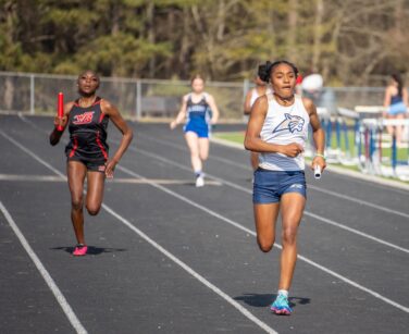 An Apalachee track runner competes against a rival from Winder-Barrow.