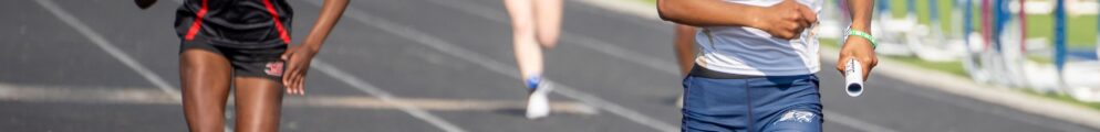 An Apalachee track runner competes against a rival from Winder-Barrow.
