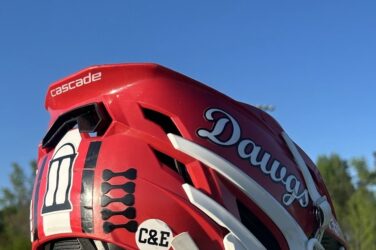 A lacrosse helmet with a sticker celebrating the coach's infant sons.