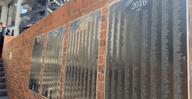 Senior Signature plaques displaying hundreds of engraved names hang on a brick wall at the Tate Student Center Plaza at the University of Georgia.