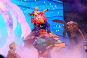 An actor and puppet on stage