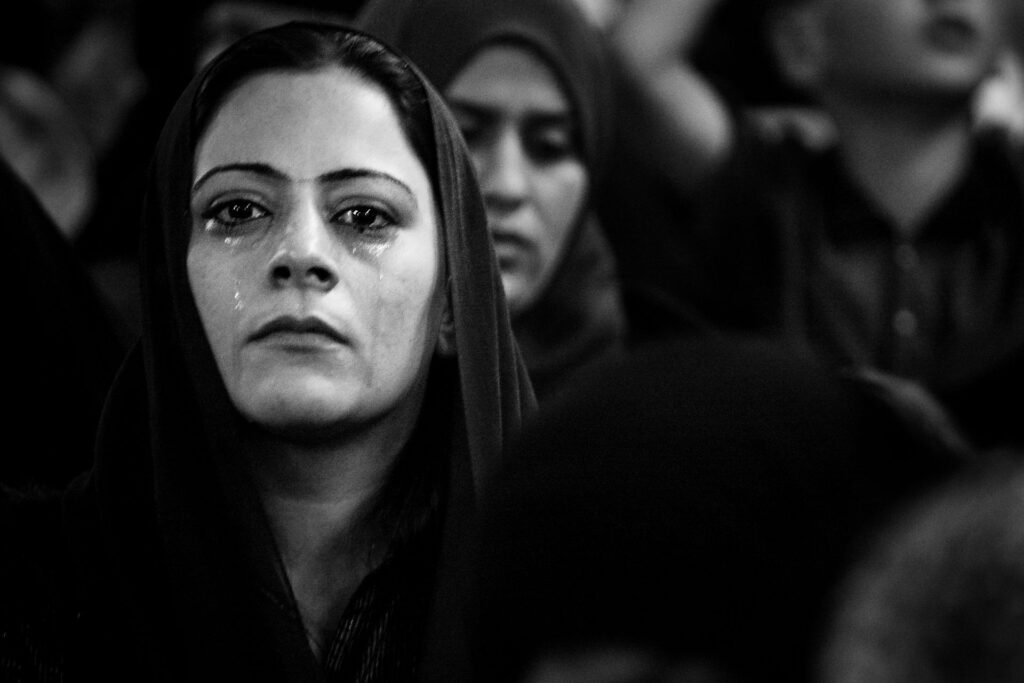 Camp Bucca, Iraq, 2008 a woman in black and white with tears running down her face