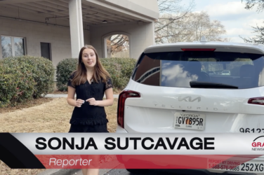 Sonja Sutcavage talks about flock cameras next to a white car