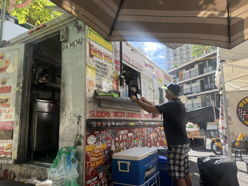 A person shops in an outdoor market stall