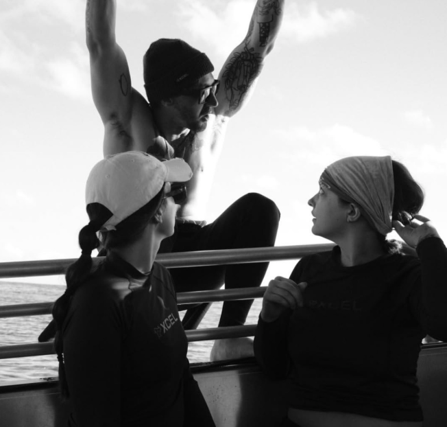 People sit on a boat in the open water