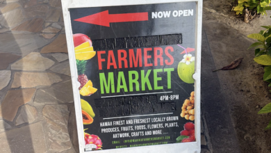 Farmers market sign set up on a cobblestone street