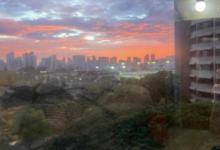 A pink sunset out of the high-rise dorm of a University of Hawaii window