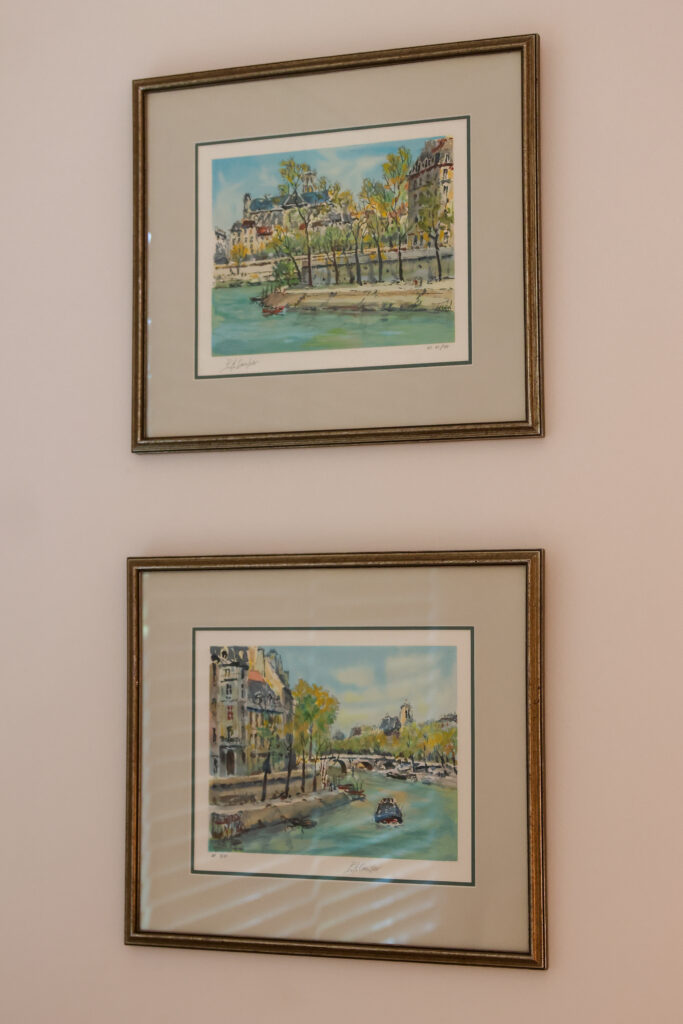 Two framed Paris prints hang on a wall.
