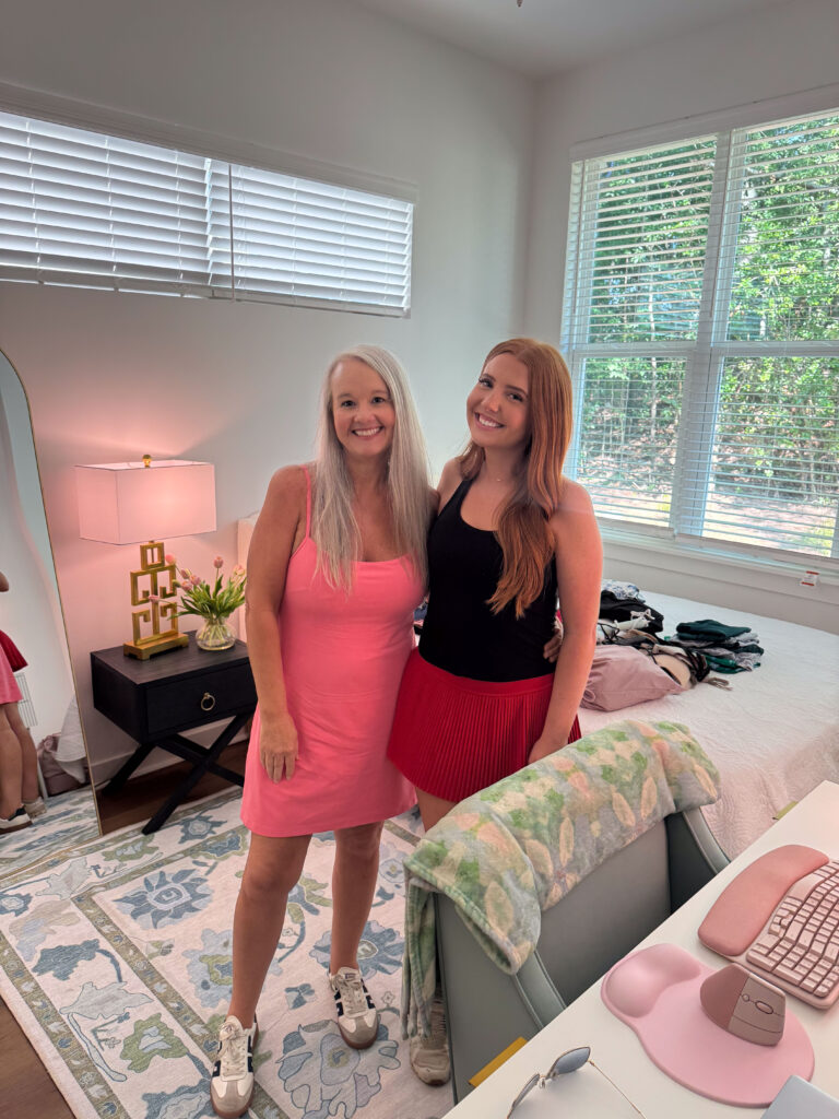 Maddie and her mother stand together in her bedroom.