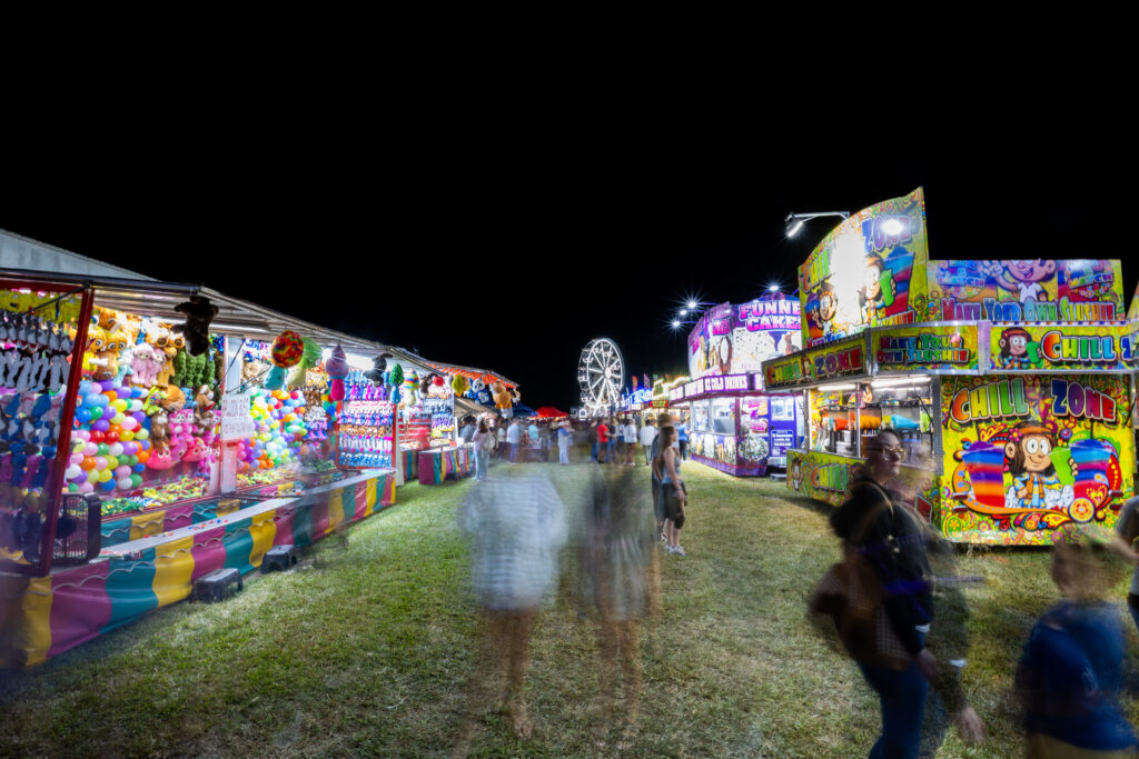 lights shine brightly on a fair midway