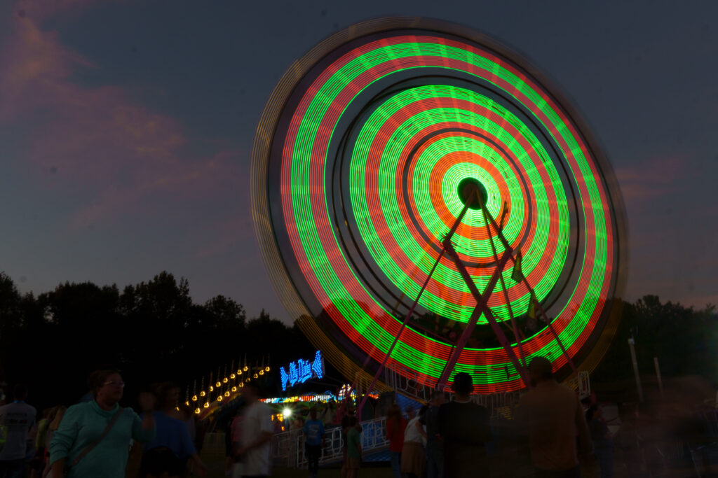 spinning lights from a ferris wheel at a fair