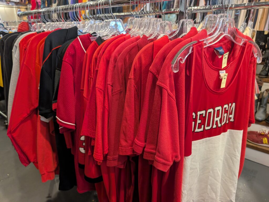 A clothing rack of red and black vintage Georgia apparel sits inside of Dynamite Clothing in downtown Athens, Georgia.