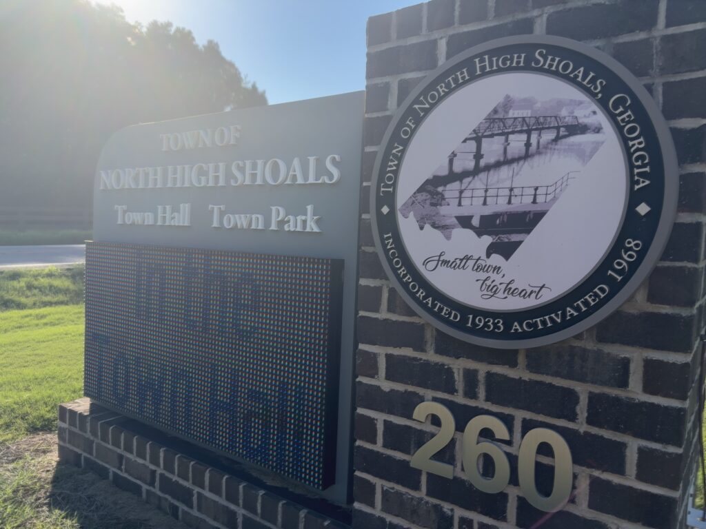 A brick sign with a digital screen. The words on the brick reads "Town of North High Shoals Town Hall" and "Town Park"